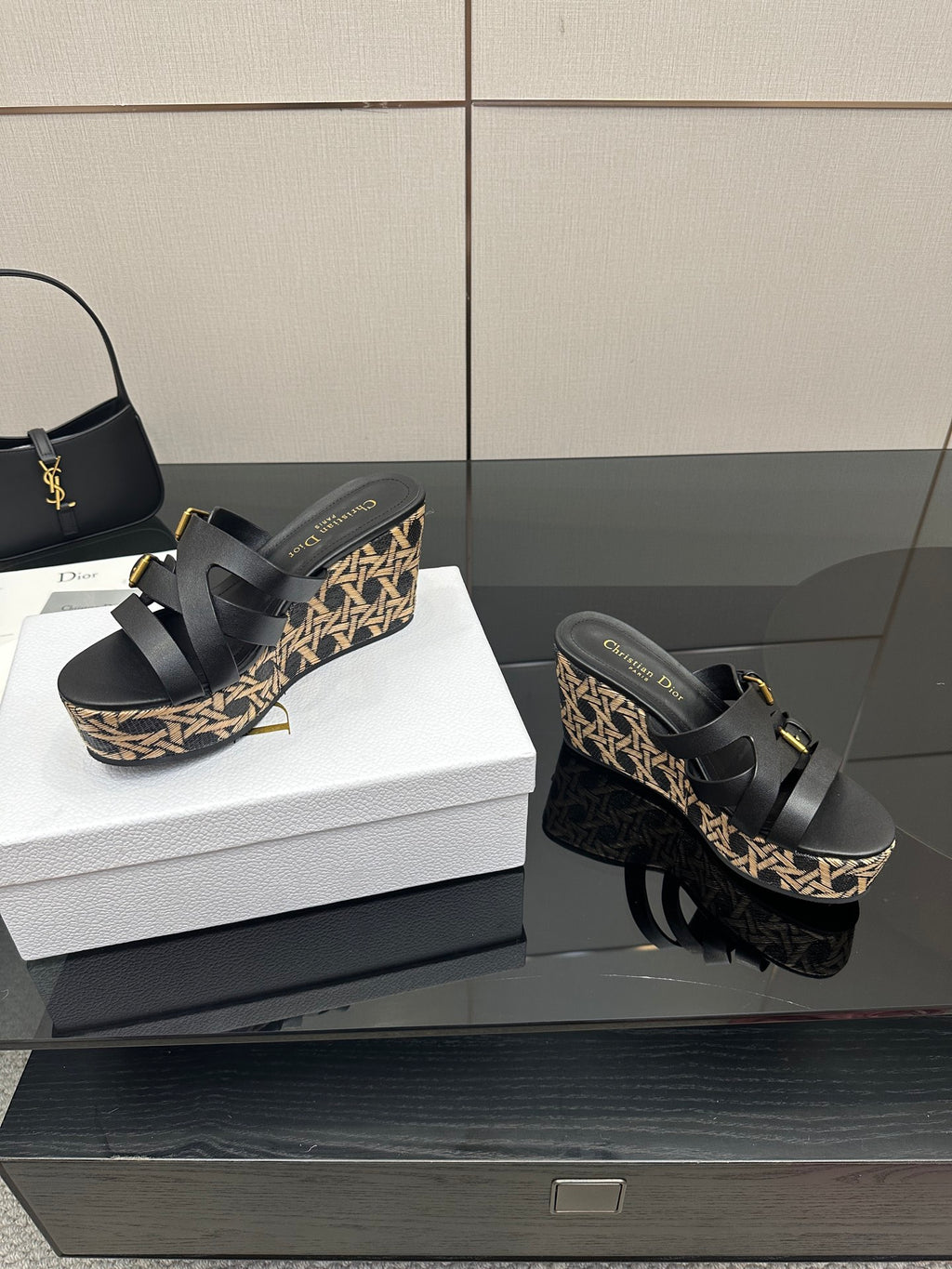 Black platform wedge sandals with patterned sides and gold-tone buckles