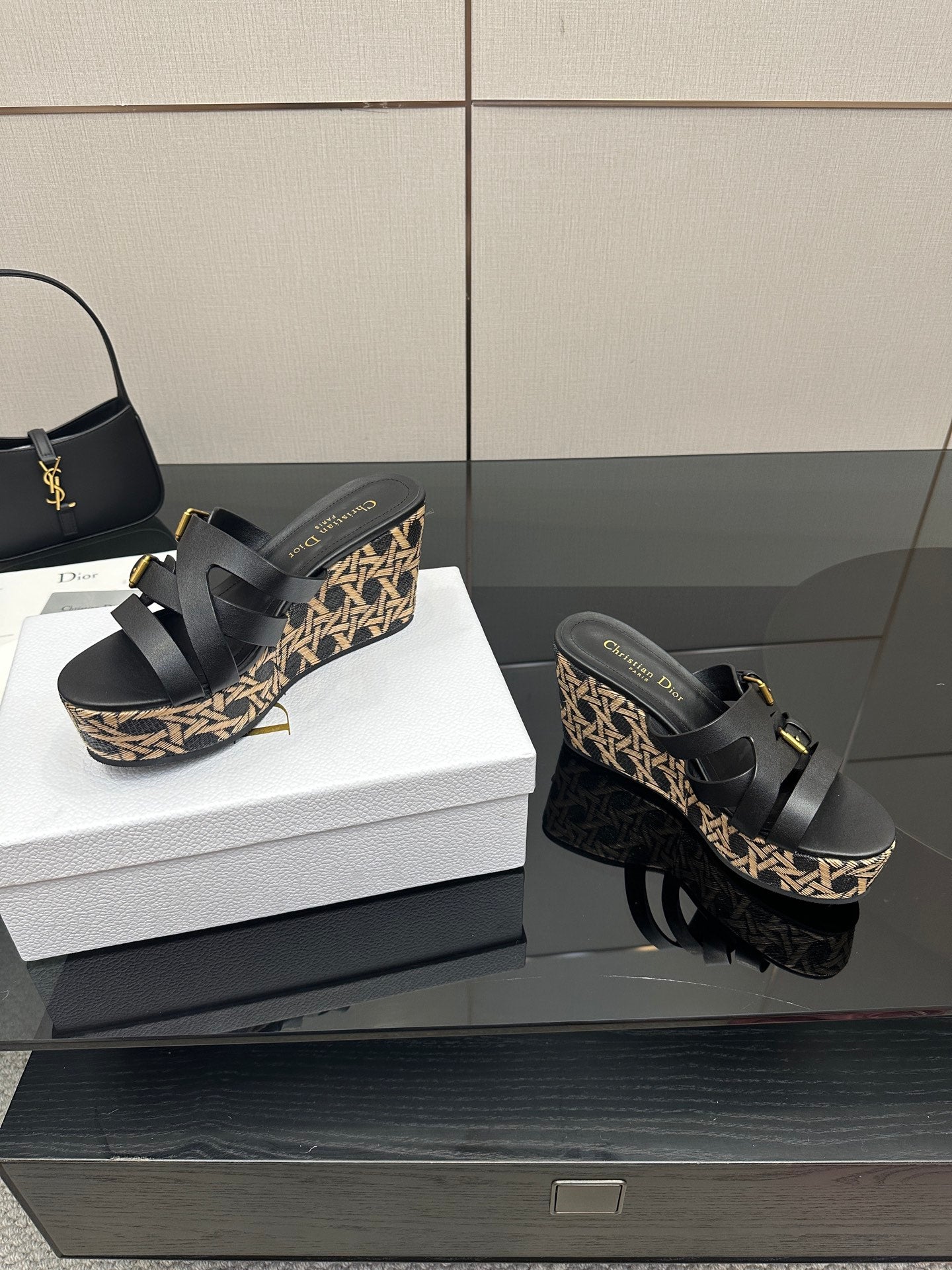 Black platform wedge sandals with patterned sides and gold-tone buckles
