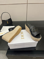Black Dior wedge slide sandals with gold buckle and espadrille platform, side view