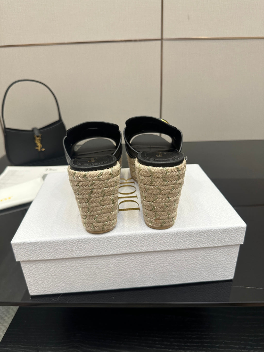 Black wedge sandals with gold buckle and espadrille heels, back view pair