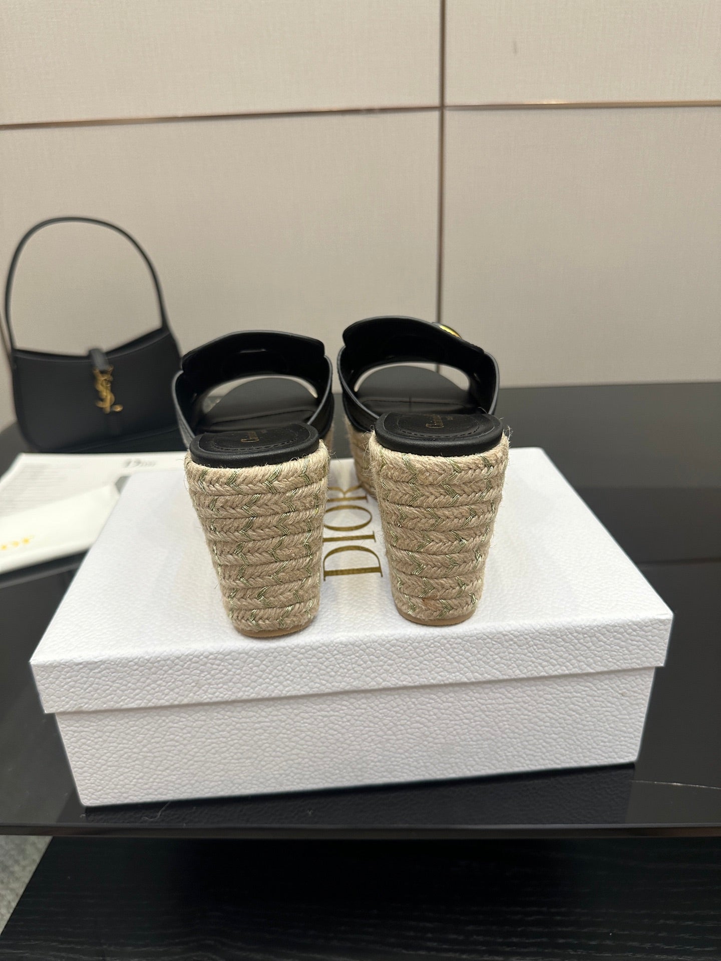 Black wedge sandals with gold buckle and espadrille heels, back view pair