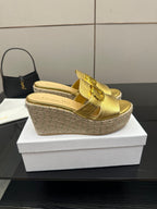 Gold leather wedge mules with buckle straps and espadrille-wrapped wedge heel.