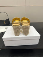 Back view of gold leather wedge mules with open heel and jute espadrille soles.