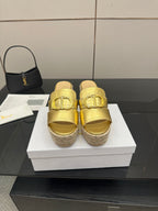 Gold leather wedge mules with front buckle and jute espadrille platform.