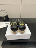 Black leather wedge mule with gold Dior-style buckle, jute platform, open toe.