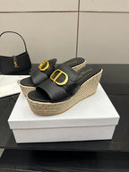 Black slide wedge mule with gold buckle detail, jute espadrille platform.