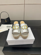 Silver slip-on wedge sandals with gold buckle strap and woven jute platform