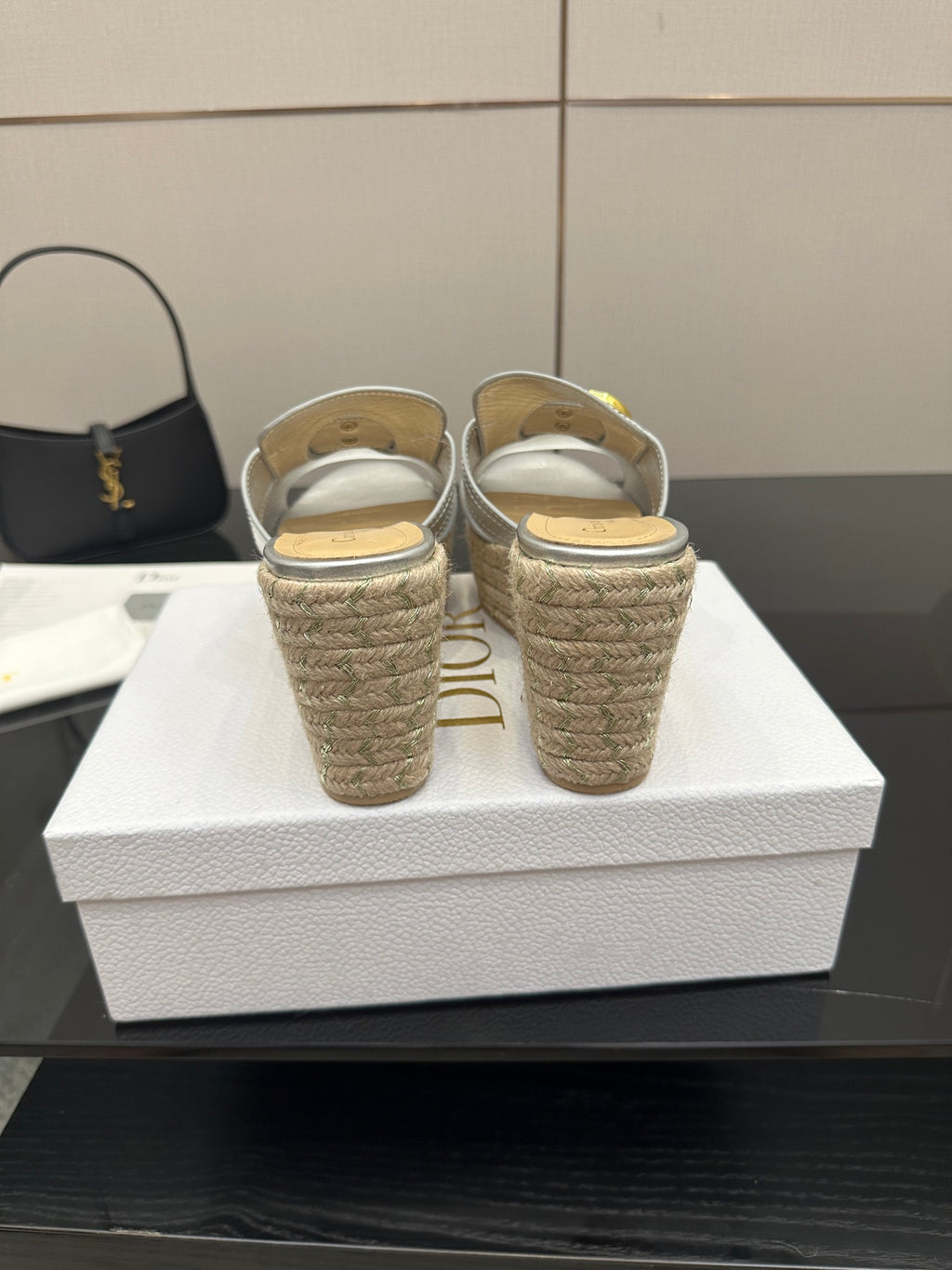 Back view of silver wedge mule sandals with woven jute heel and footbed