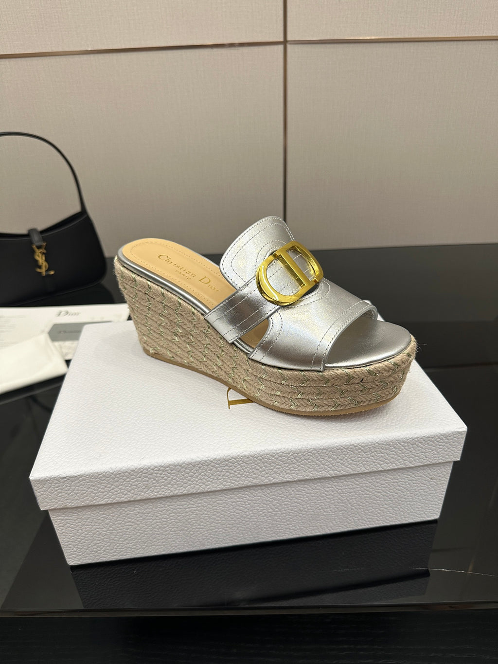 Silver slip-on wedge mule with gold buckle strap and textured jute platform