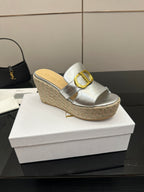 Silver slip-on wedge mule with gold buckle strap and textured jute platform