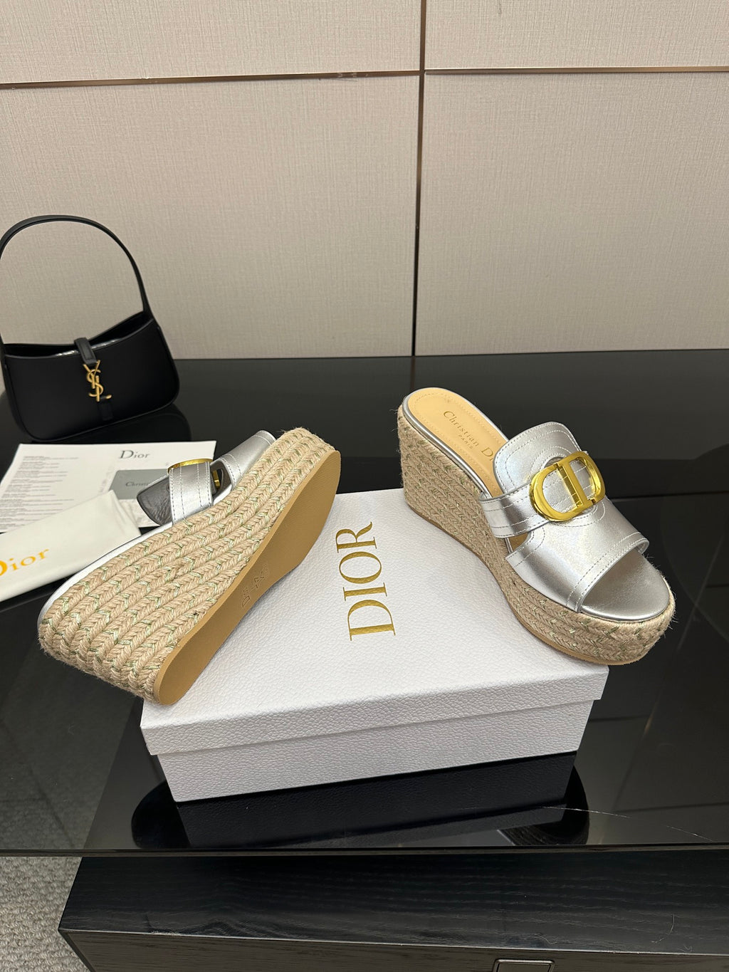 Silver wedge mule sandals with gold buckle strap and textured jute platform, side view