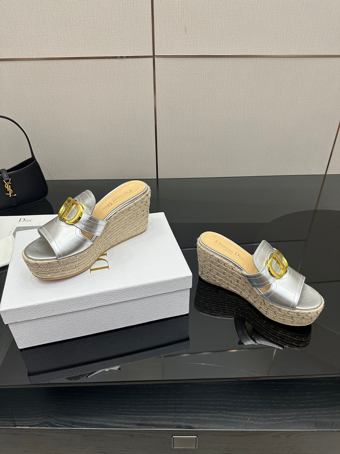 Silver wedge mule sandals with gold buckle strap and braided jute heel