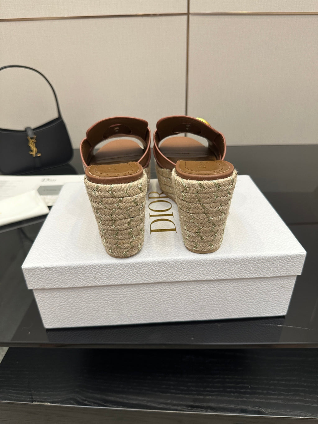 Brown leather wedge slide sandals with gold D hardware; heel shows Dior logo