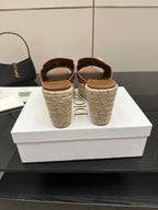 Brown leather wedge slide sandals with gold D hardware; heel shows Dior logo