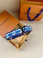 Blue and white patterned belt with gold buckle, folded in box