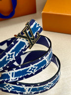 Close-up of blue and white monogram belt and gold buckle