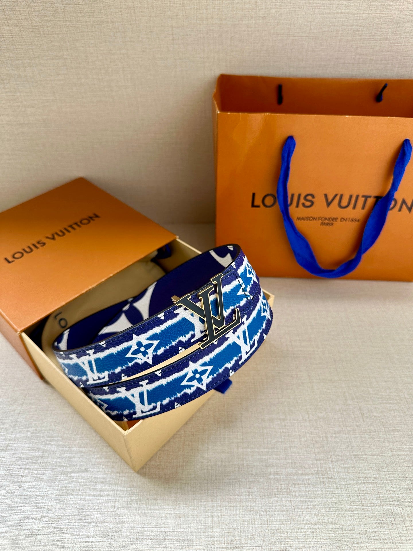 Blue and white monogram belt with gold buckle, gift-box view