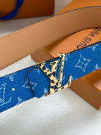 Blue logo-pattern belt detail with gold buckle and tan leather strap backing