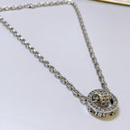 Silver-tone chain necklace with round Balenciaga monogram pendant, close-up