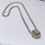 Silver-tone chain necklace with round monogram pendant