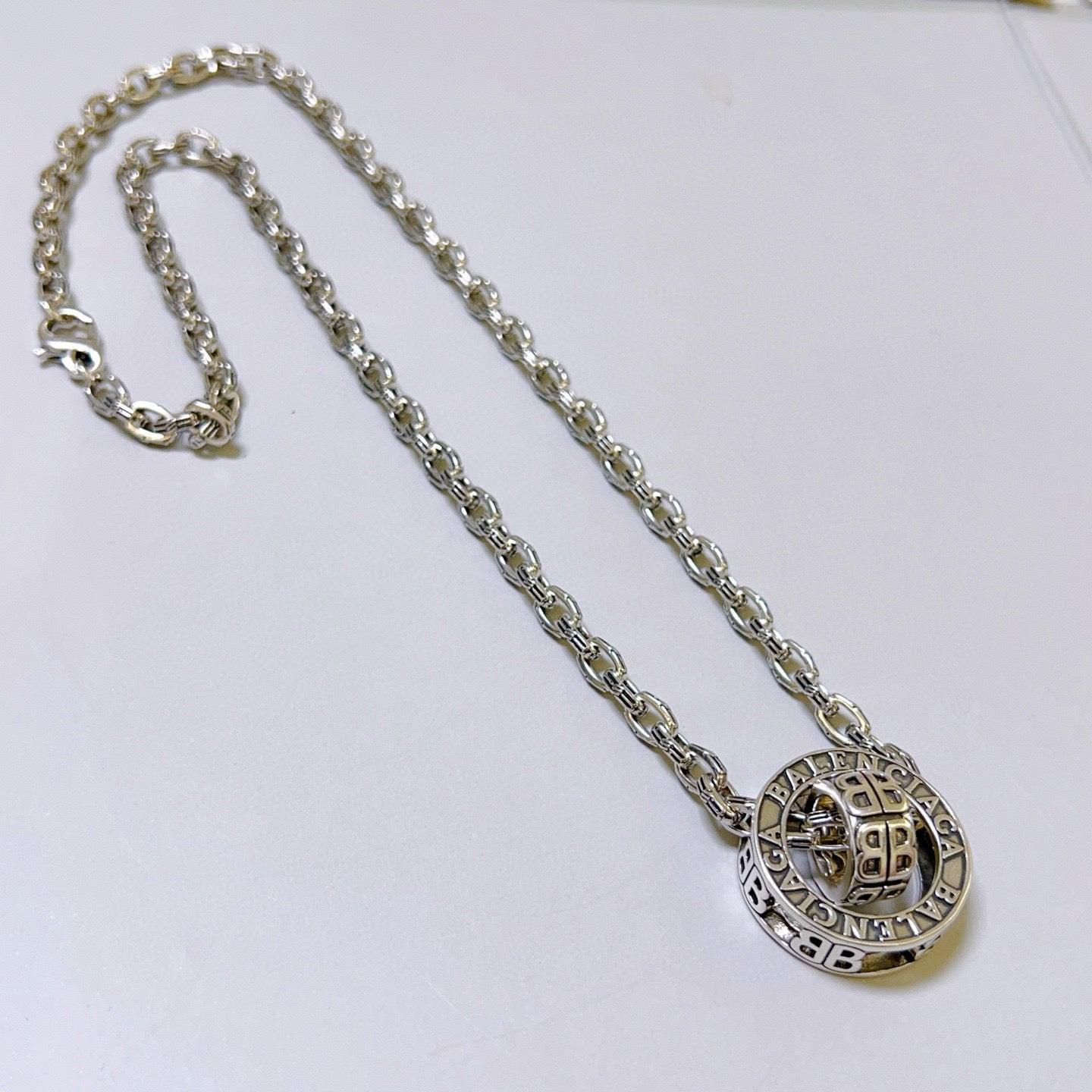 Silver-tone chain necklace with round monogram pendant