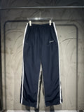 Balenciaga pants with elastic waistband, dark navy fabric and white side stripe