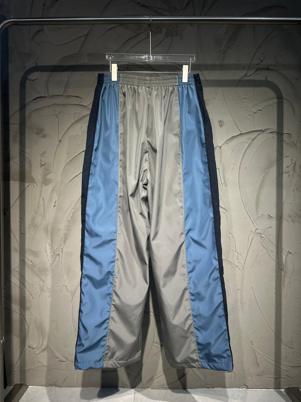 Balenciaga pants with elastic waistband, blue and gray panels with white stripe