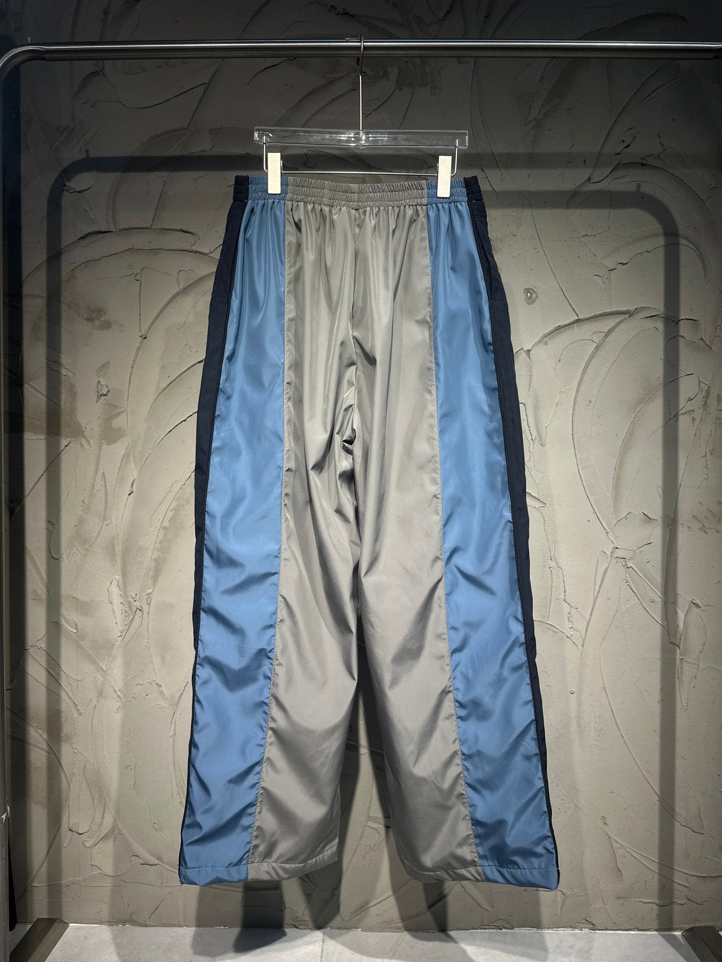 Balenciaga pants with elastic waistband, blue and gray panels with white stripe