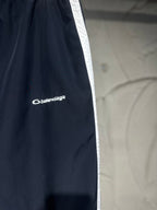 Balenciaga pants side with white stripe and Balenciaga logo on dark fabric