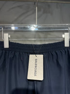 Balenciaga pants with black elastic waistband and hanging Balenciaga brand tag