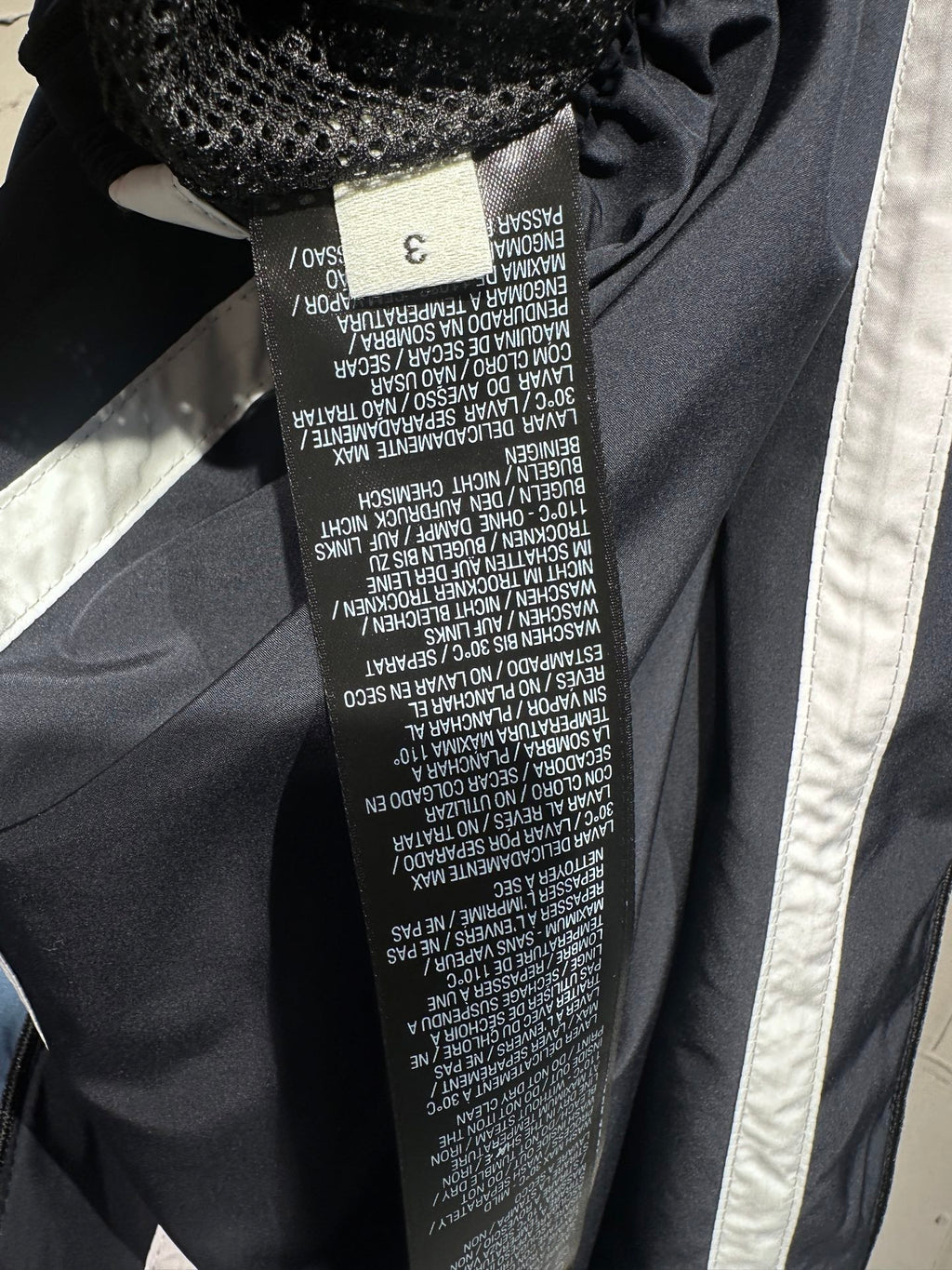 Balenciaga pants care label inside seam with printed size and washing text