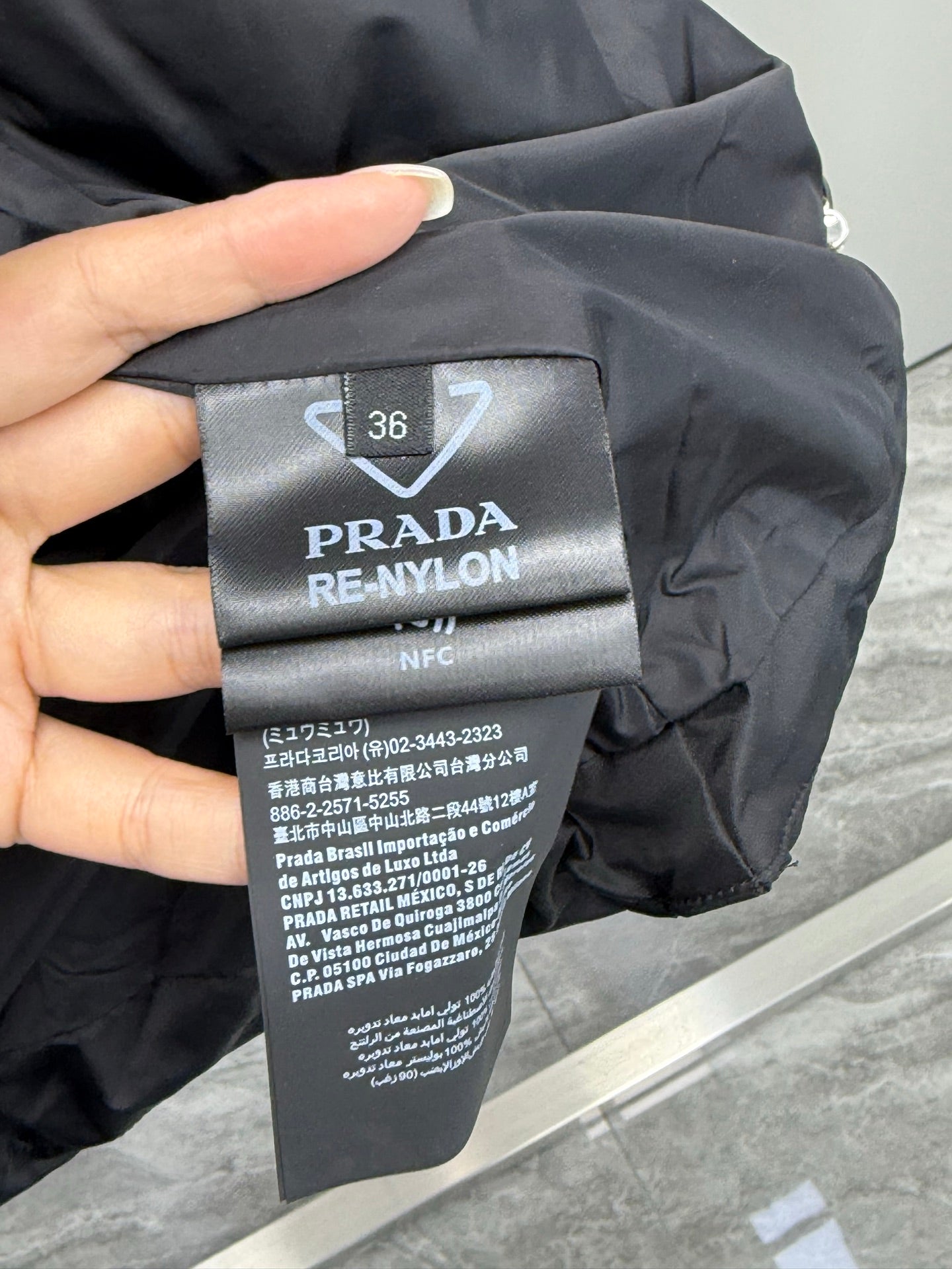 Prada RE-NYLON size and care label marked 36 on black puffer coat