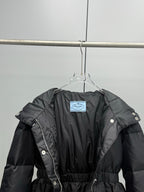 Prada black puffer coat with belt and hood, front view with interior tag