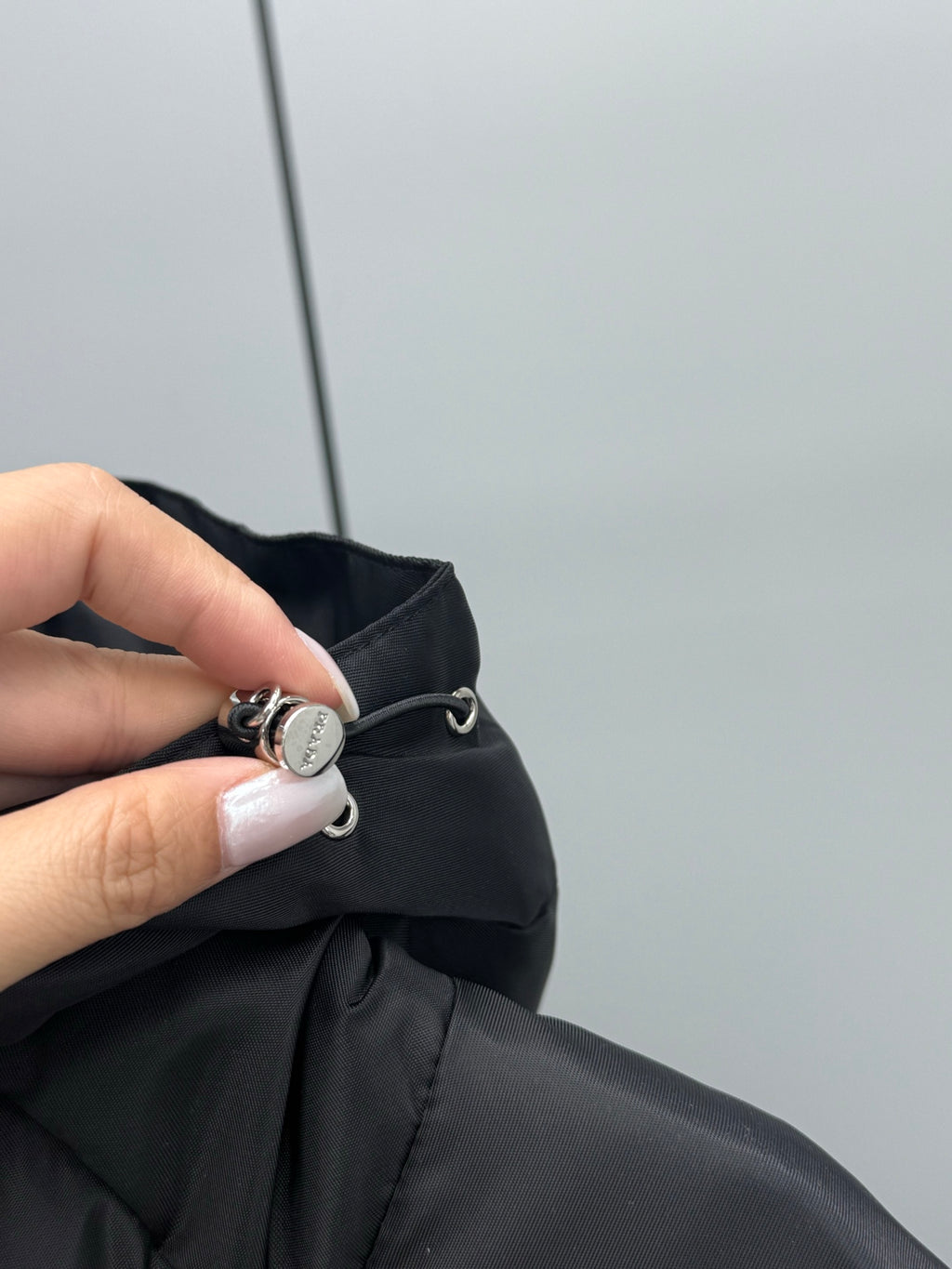 Prada black puffer coat neckline with round metal snap clasp