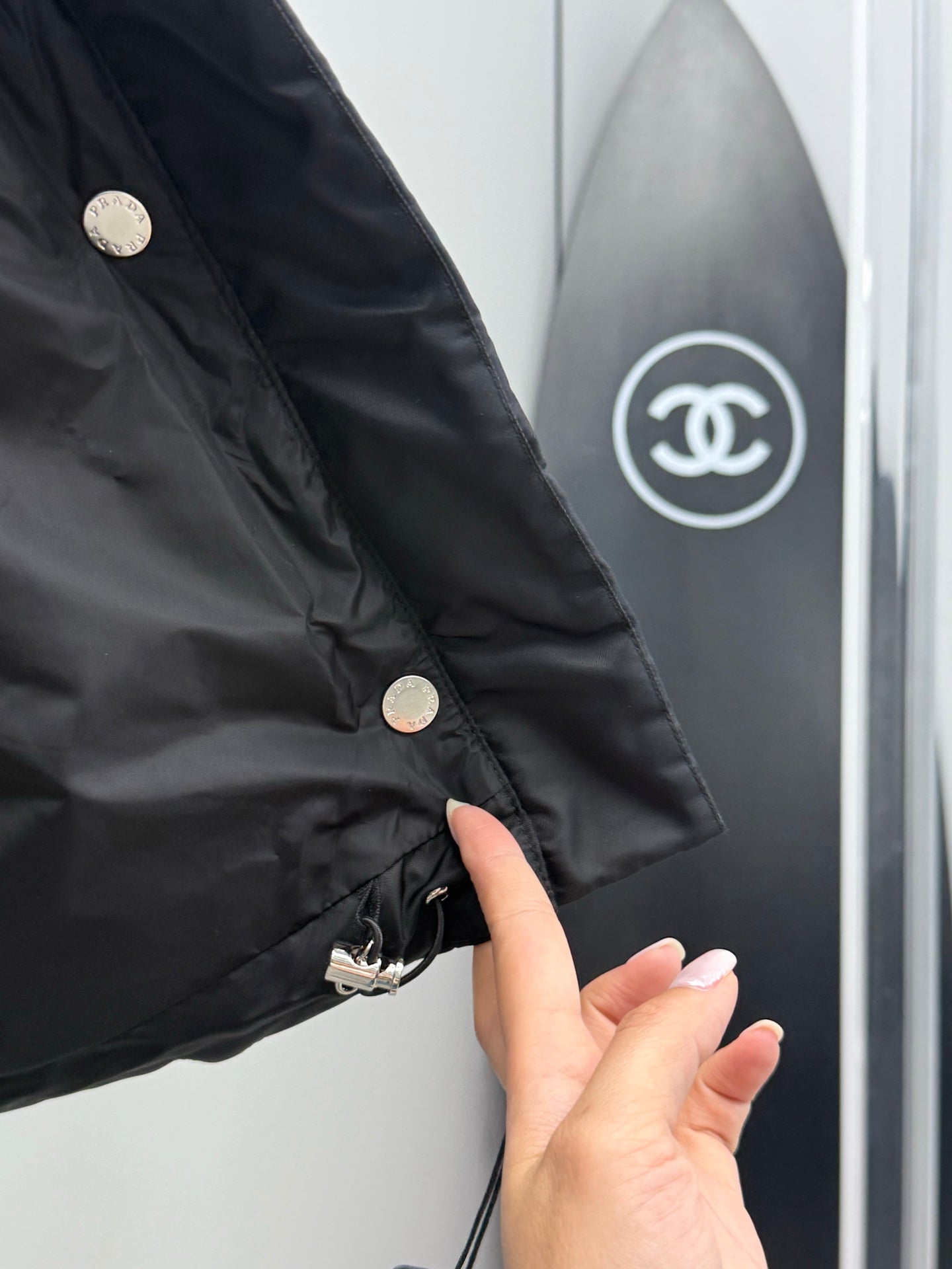 Prada black puffer coat sleeve with metal snap buttons and small logo detail