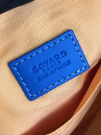 Blue leather brand patch with Goyard Paris text on bag interior lining.