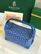 Blue Goyard-pattern shoulder bag with long strap and zipper closure.