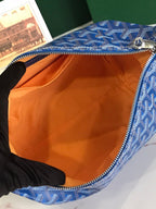 Blue zip-top bag interior with orange lining and patterned fabric edge.