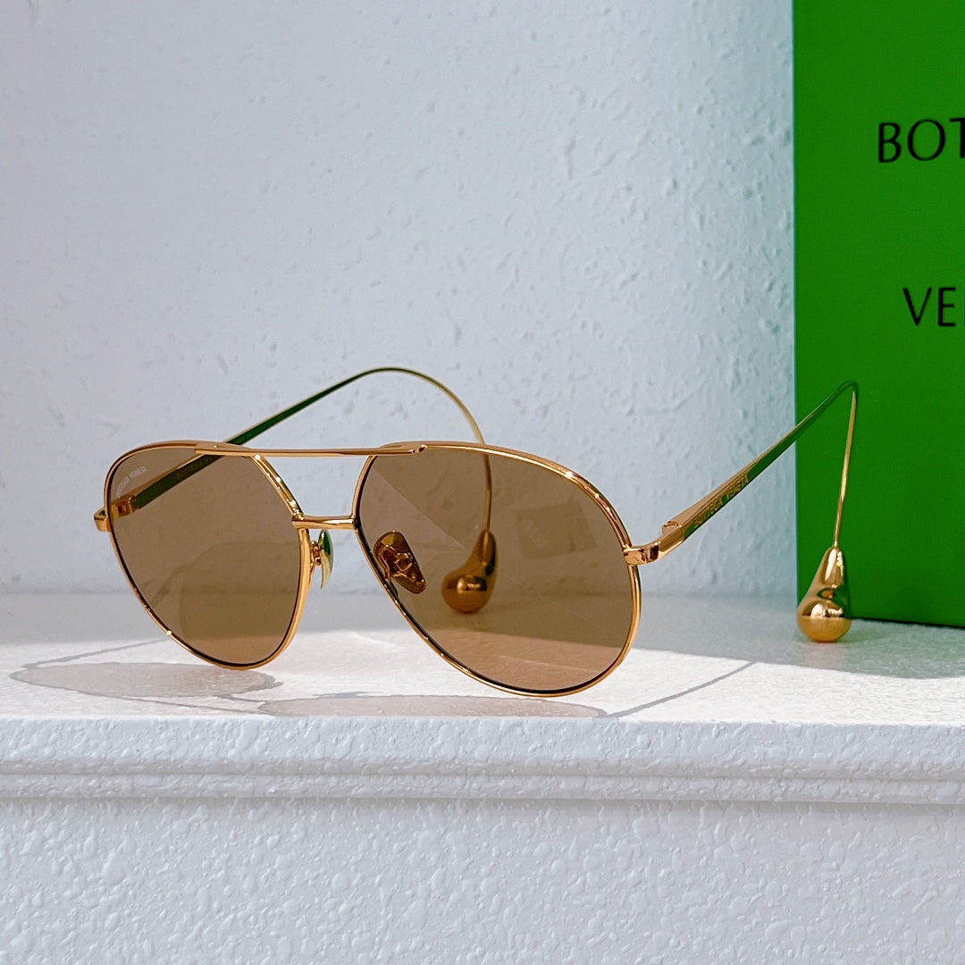 Gold-frame sunglasses with light brown tinted lenses and thin metal arms