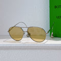 Gold-frame sunglasses with round lenses and mirrored yellow tint