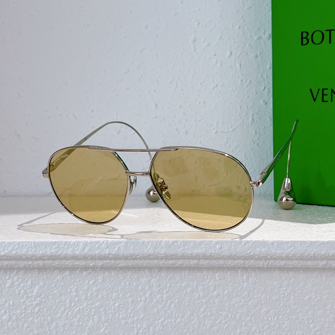 Gold-frame sunglasses with round lenses and mirrored yellow tint