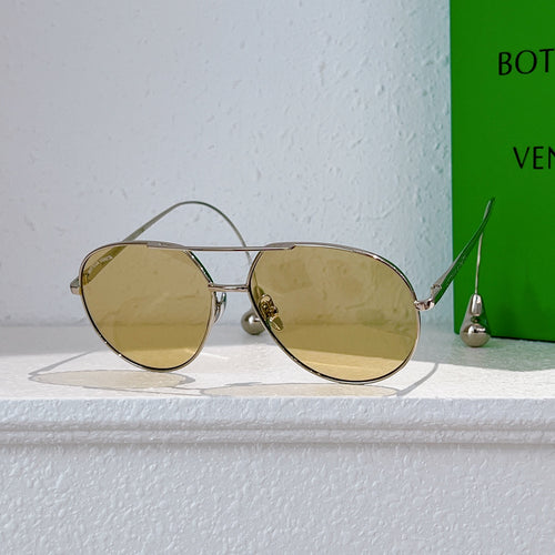 Gold-frame sunglasses with round lenses and mirrored yellow tint