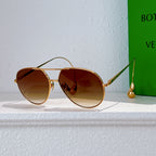 Gold-frame sunglasses with amber tinted lenses and thin metal arms