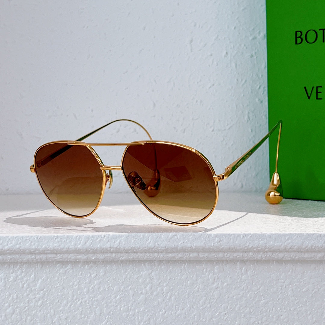 Gold-frame sunglasses with amber tinted lenses and thin metal arms