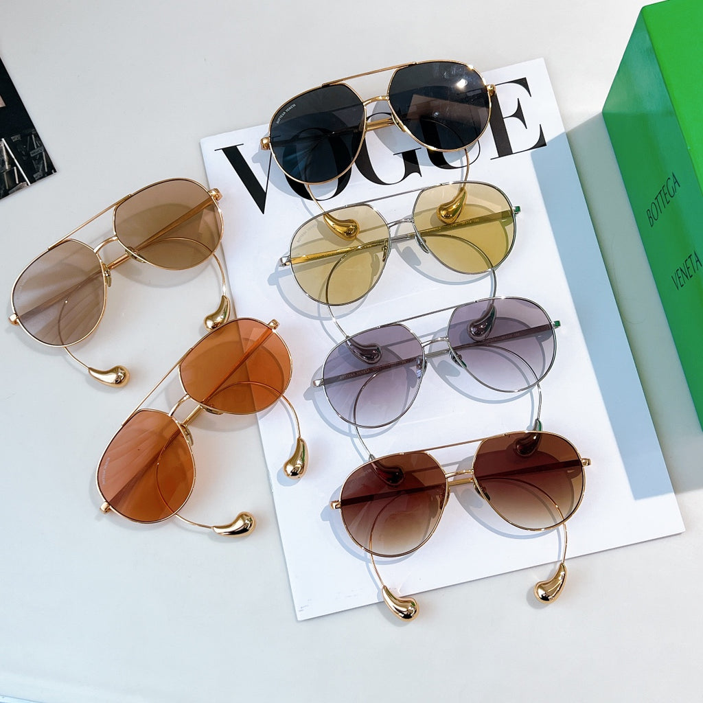 Set of multiple tinted sunglasses in gold and silver frames on display