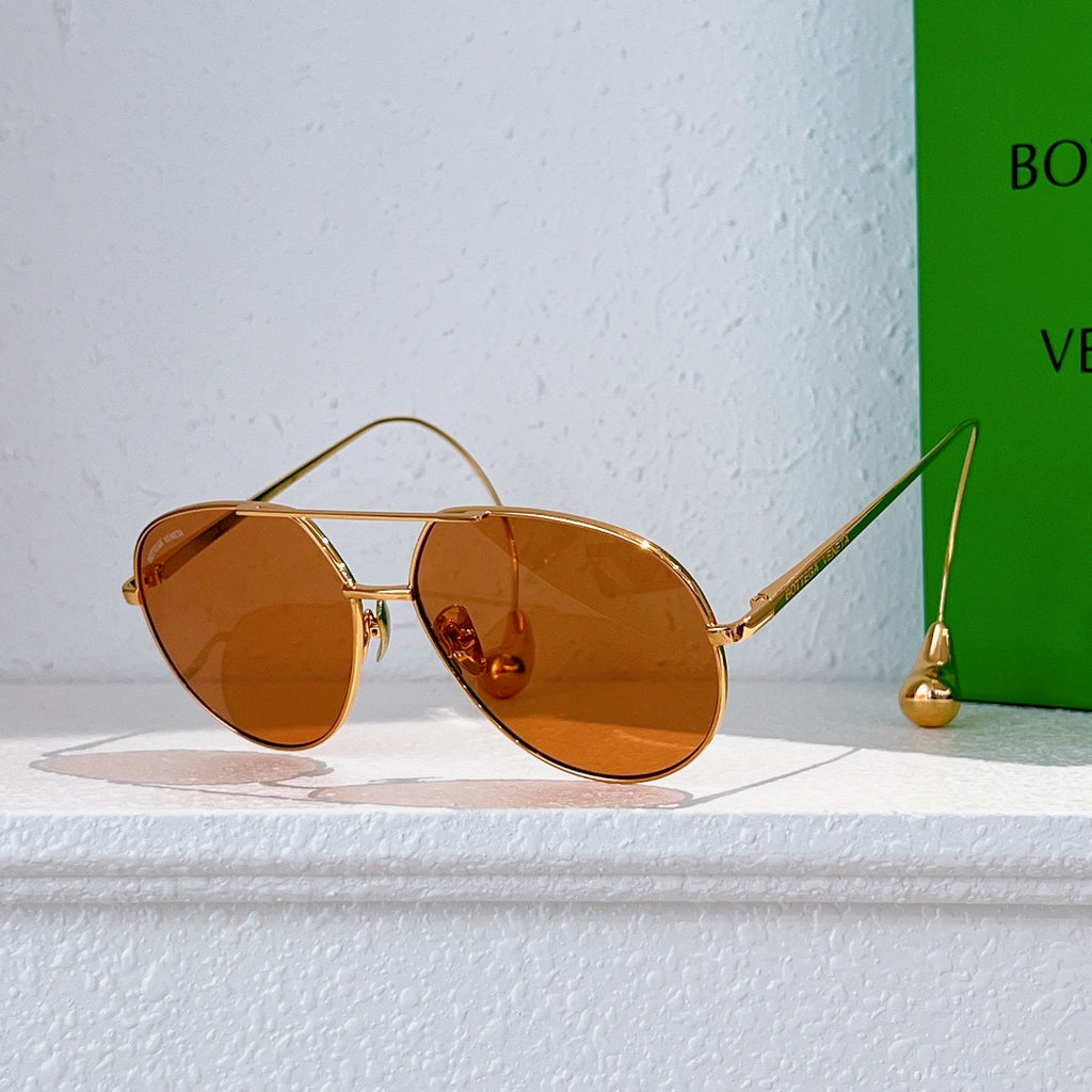 Gold-frame sunglasses with warm brown tinted lenses and thin metal arms