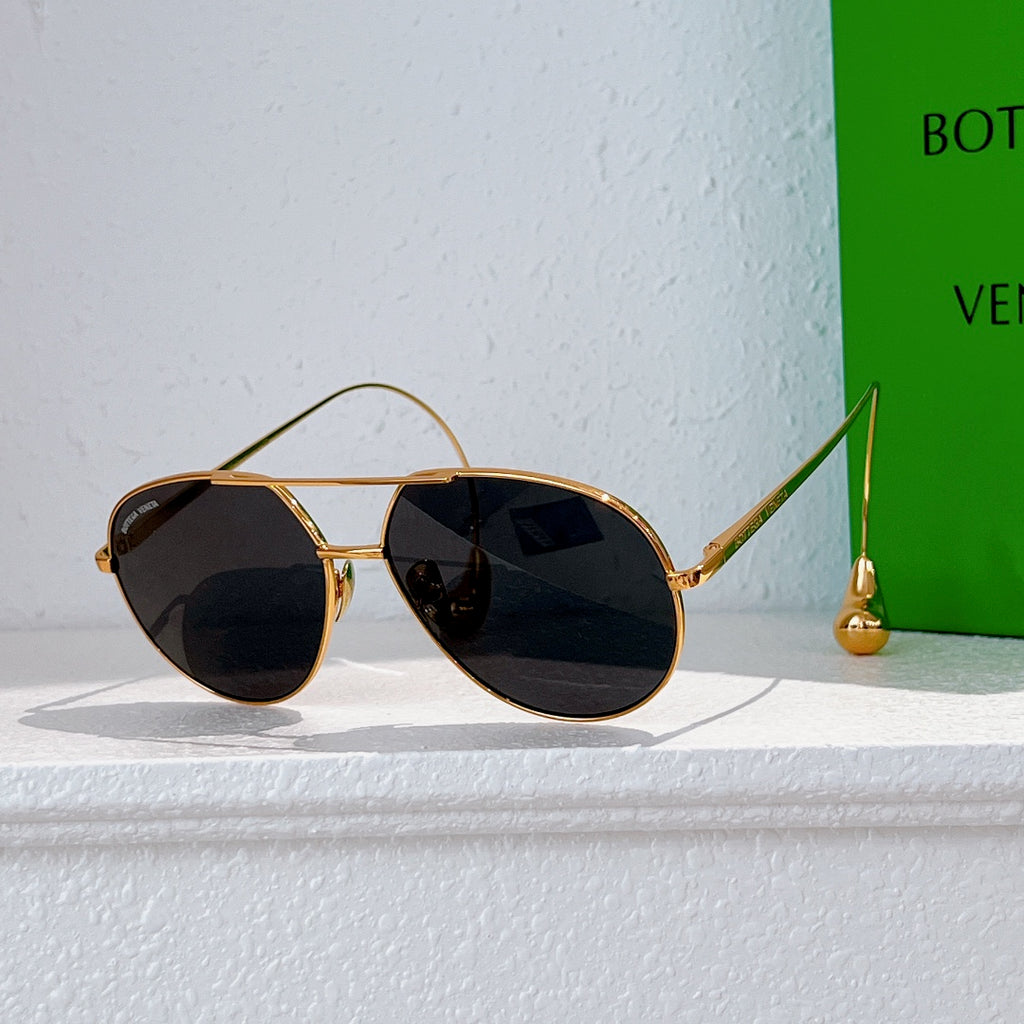 Gold-frame sunglasses with black tinted lenses and thin metal arms