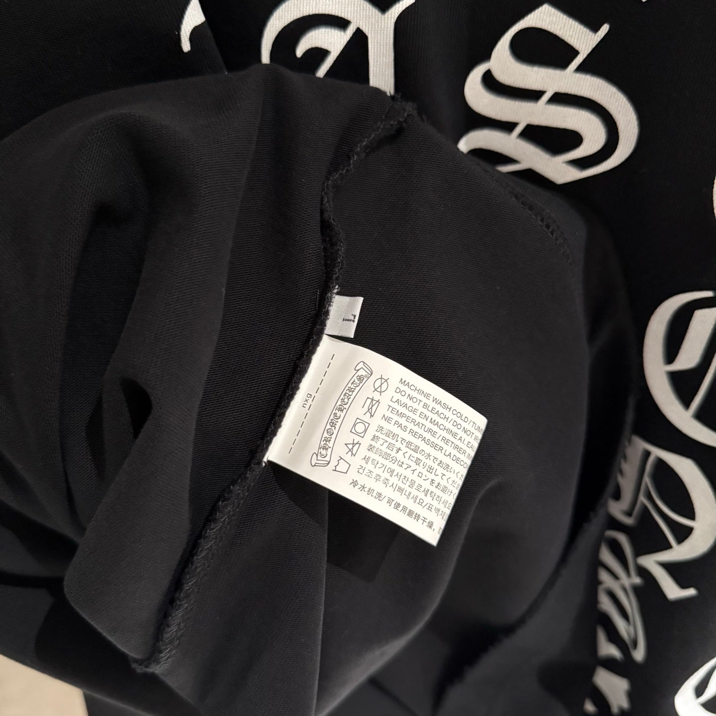 Black long-sleeve sweatshirt neck label tag inside collar