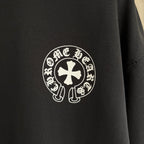 Black long-sleeve sweatshirt close-up of circular cross-style logo emblem