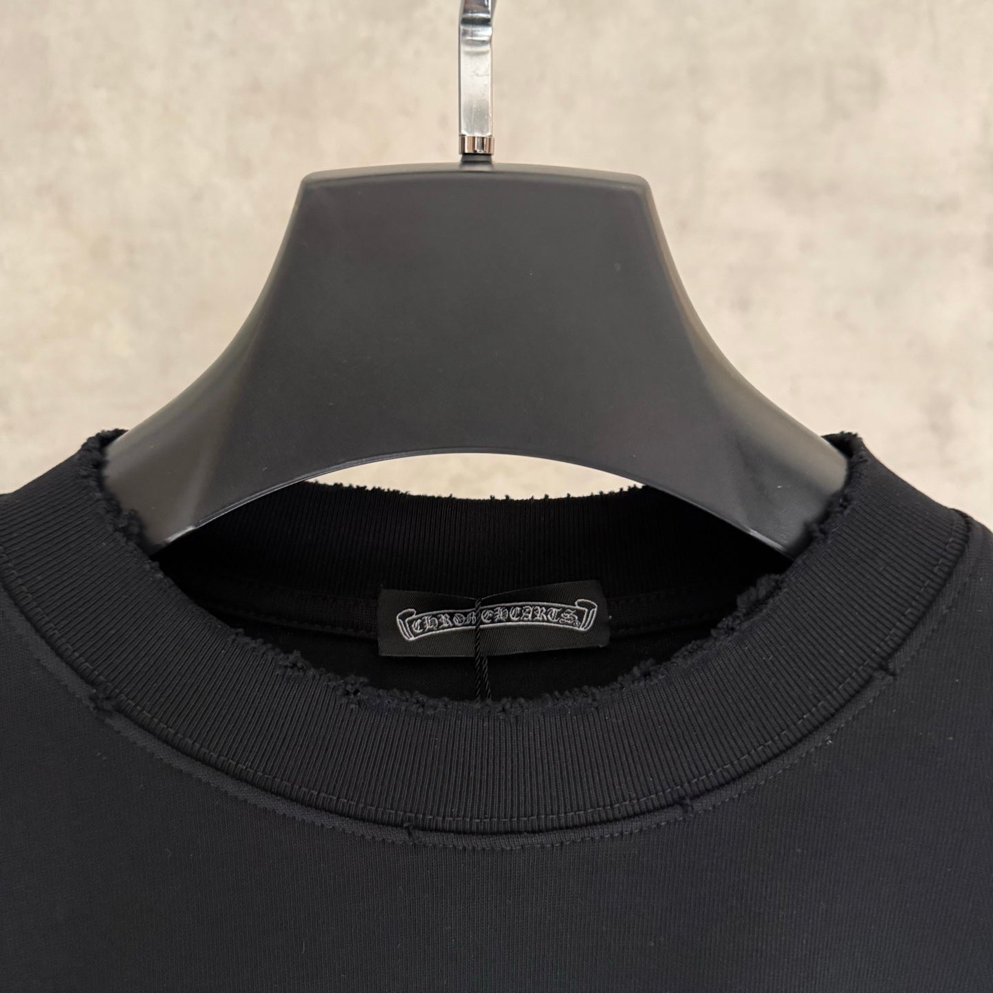 Black long-sleeve crewneck sweatshirt collar with ribbed neckline and seam detail